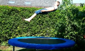 kid playing on a trampoline